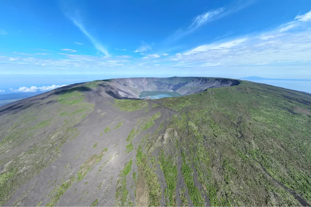 Stunning aerial view of Fernandina Island's volcano, which towers at 1,476 meters (approximately 0.917 miles) above sea level.