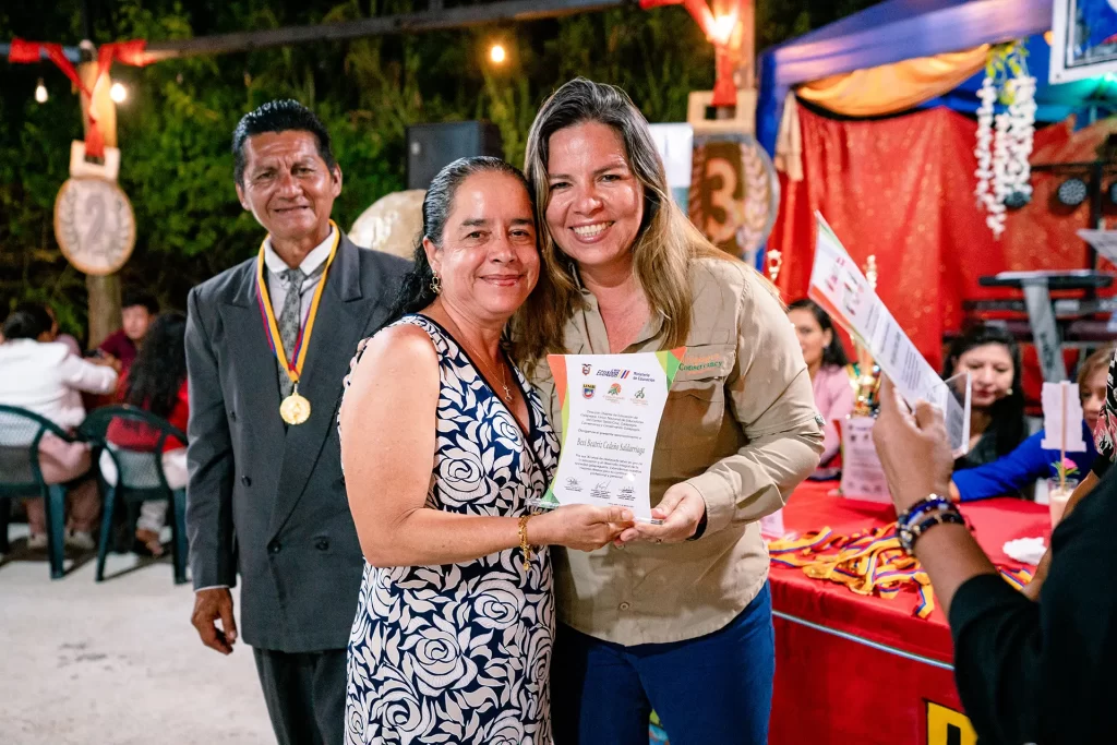 Bexi Cedeño (center) receives a certificate of honor for her 30 years of service as a teacher alongside Jenny Macías, our expert in environmental education.